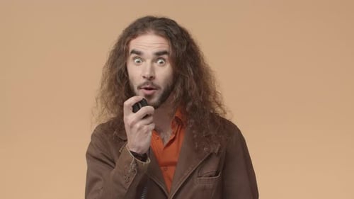 Man Speaking Into Microphone with Excited Facial Expression