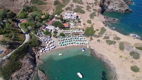 Drone aerial view of Mediterranean village beach on Crete, Greece. Hotel, vacation, travel concept