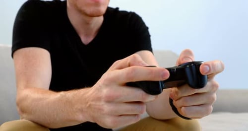 Young Man Playing Video Game Enthusiastically