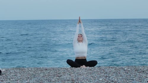 Fitness Outdoors a Woman Doing Yoga By the Blue Sea