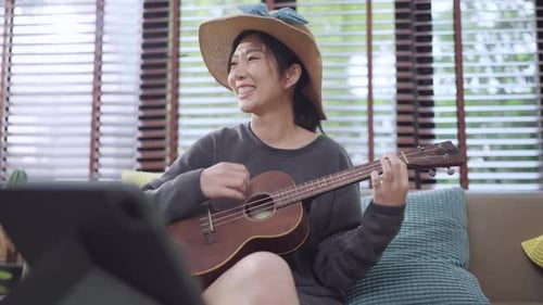 Happy Woman Plays Ukulele and Sings
