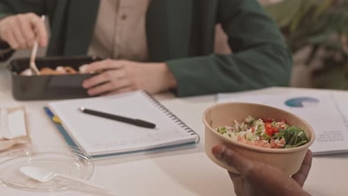 Co-workers Eating Lunch at the Office Desk