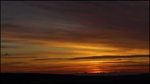 Timelapse of Sunrise on the Field with Clouds in the Sky and Orange Red Tones