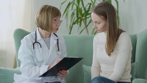 Doctor and Patient are Discussing at Clinic Sitting on the Couch
