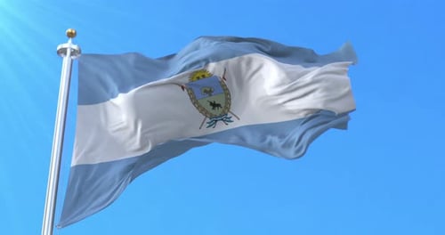 Realistic Waving Flag with Coat of Arms Against Blue Sky