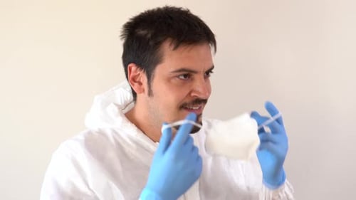 Man Putting on a Face Mask and Protective Gear