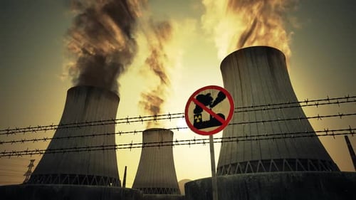 Nuclear power plant steaming cooling towers. Air pollution power station.Sunset