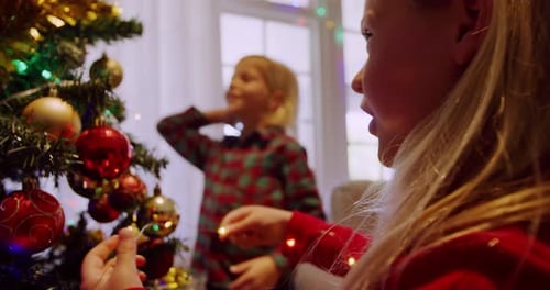 Children Decorating Christmas Tree with Lights and Ornaments