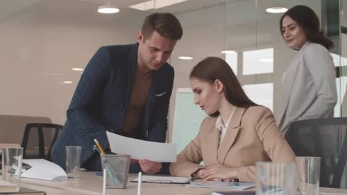 Team Discusses Report in Bright Office