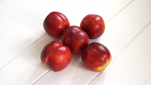 Fresh Red Nectarines on White Wooden Background