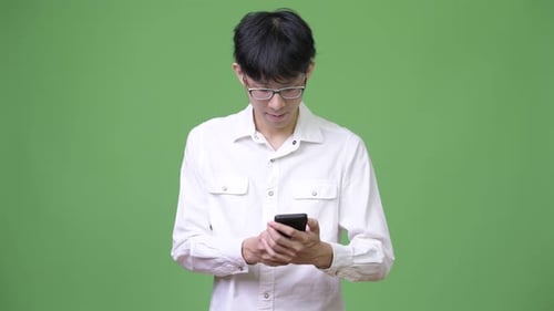Young Adult Using Smartphone on Green Screen