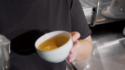 Pouring Milk Into Coffee to Create Latte Art