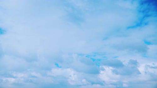 Fluffy Clouds Drifting Across a Bright Blue Sky