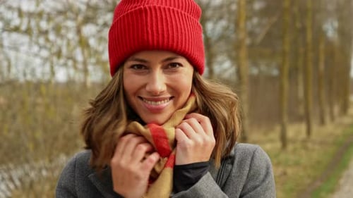 Smiling Woman in Red Hat and Scarf Outdoors