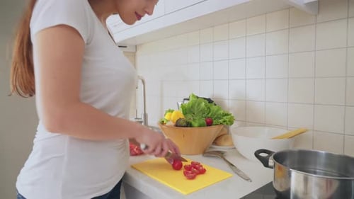 Woman Prepares Food in Kitchen