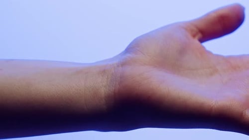 Hand Skin in Blue Neon Light Making Xray of Human Body Part Arm Surface Macro Shooting