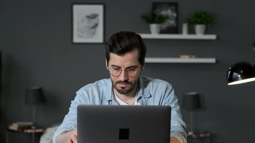 Young Adult Working on Laptop from Home