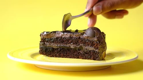 Slice of Chocolate Cake Being Cut with Spoon