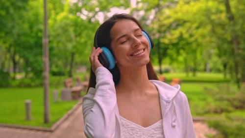 Smiling Brunette Enjoy Song Walks in City