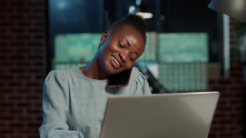 Woman Talking on Phone in Front of Computer