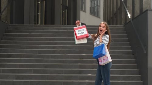 Woman Holding Shopping Bags After Black Friday Sale