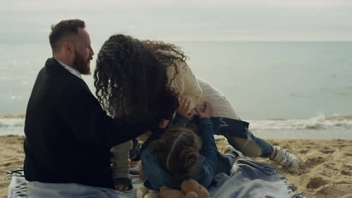 Family Laughing Enjoying Beach Together on Sea Vacation