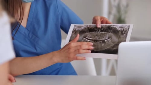 Medical Professional Examining Dental X-Ray