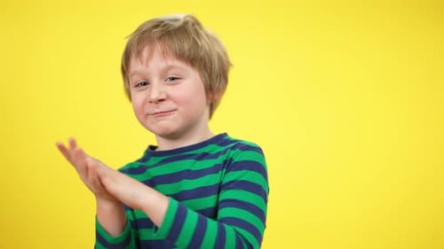 Young Child Clapping Hands with a Smile