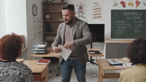 Teacher Giving Exam Sheets to Students