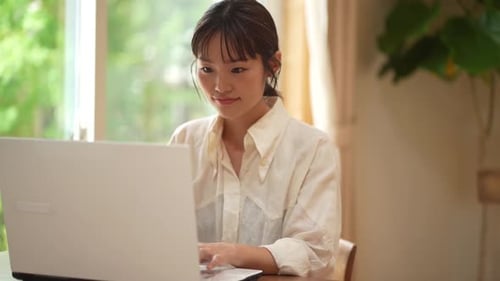 Woman Working on Laptop in Home Office