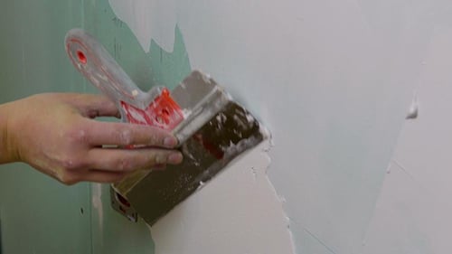 Joint Compound Applied to Wall with a Spatula