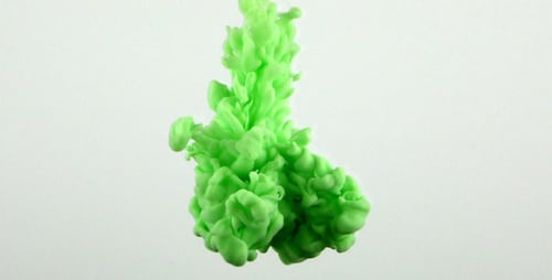 Green Ink Spreading Slowly Through Clear Water