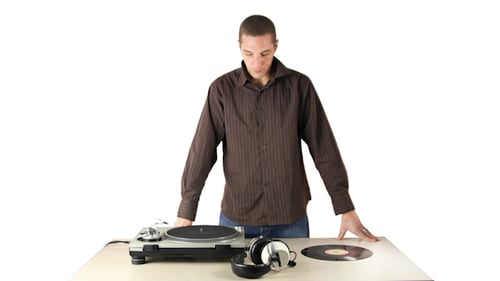 Young DJ Playing Vinyl Record on Turntable
