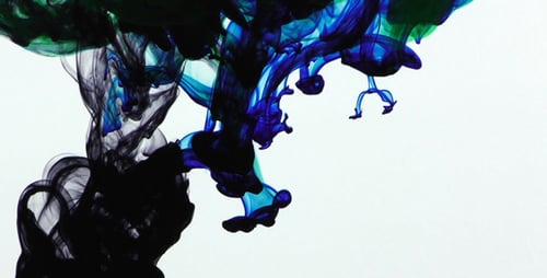 Colorful Ink Dropping Into Water Creating Abstract Shape