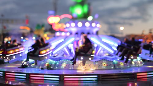 Illuminated Carnival Ride Spins at Night