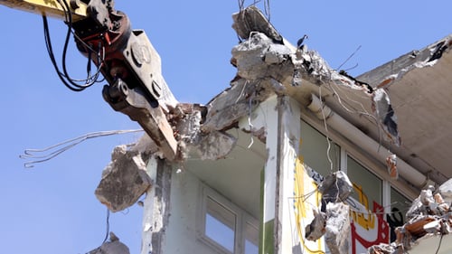 Building Demolition with Heavy Equipment in Sunny Urban Setting