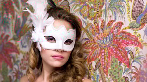 Young Woman Wearing Masquerade Mask with Colorful Background