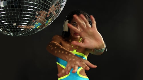 Woman Dancing near Disco Ball