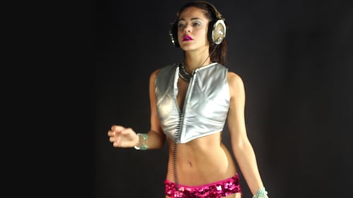 Woman Dances in Shiny Top with Headphones