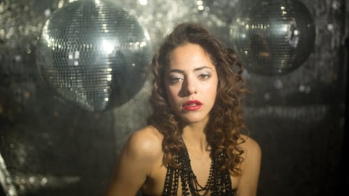 Woman in Corset with Disco Ball Background