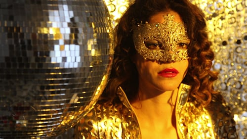 Woman in Gold Mask Posing by Disco Ball