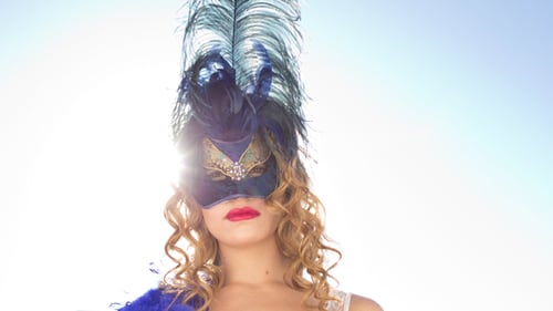 Woman Wearing Feathered Venetian Mask on Bright Day