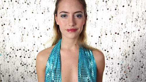 Blond Woman Dancing in a Sparkly Blue Top