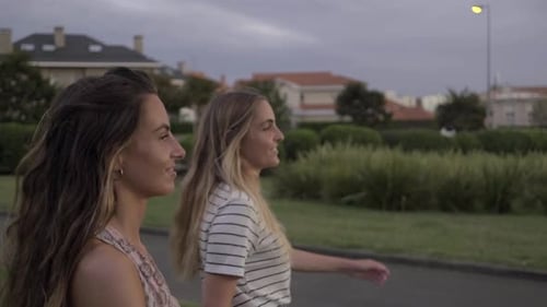 Slow motion shot of young women walking in park