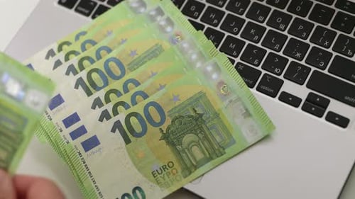 Euro Bills on Computer Keyboard Close Up