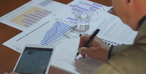 Businessman Working in Office With Charts