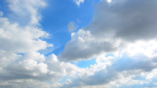 Clouds Moving Across Bright Blue Sky Time Lapse