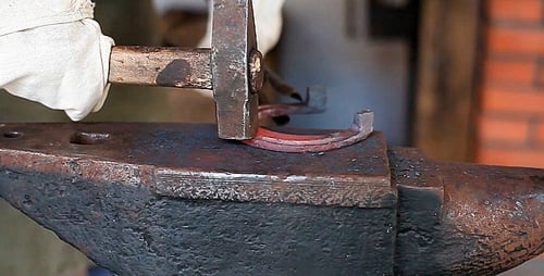 Close Up Blacksmith Forging Red Hot Horseshoe
