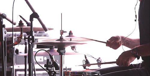 Man Playing Drums in the Studio on a White Backgro