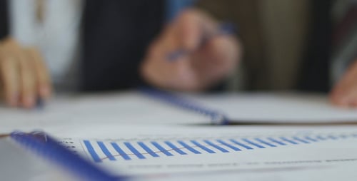Business People Reviewing Charts and Graphs Together